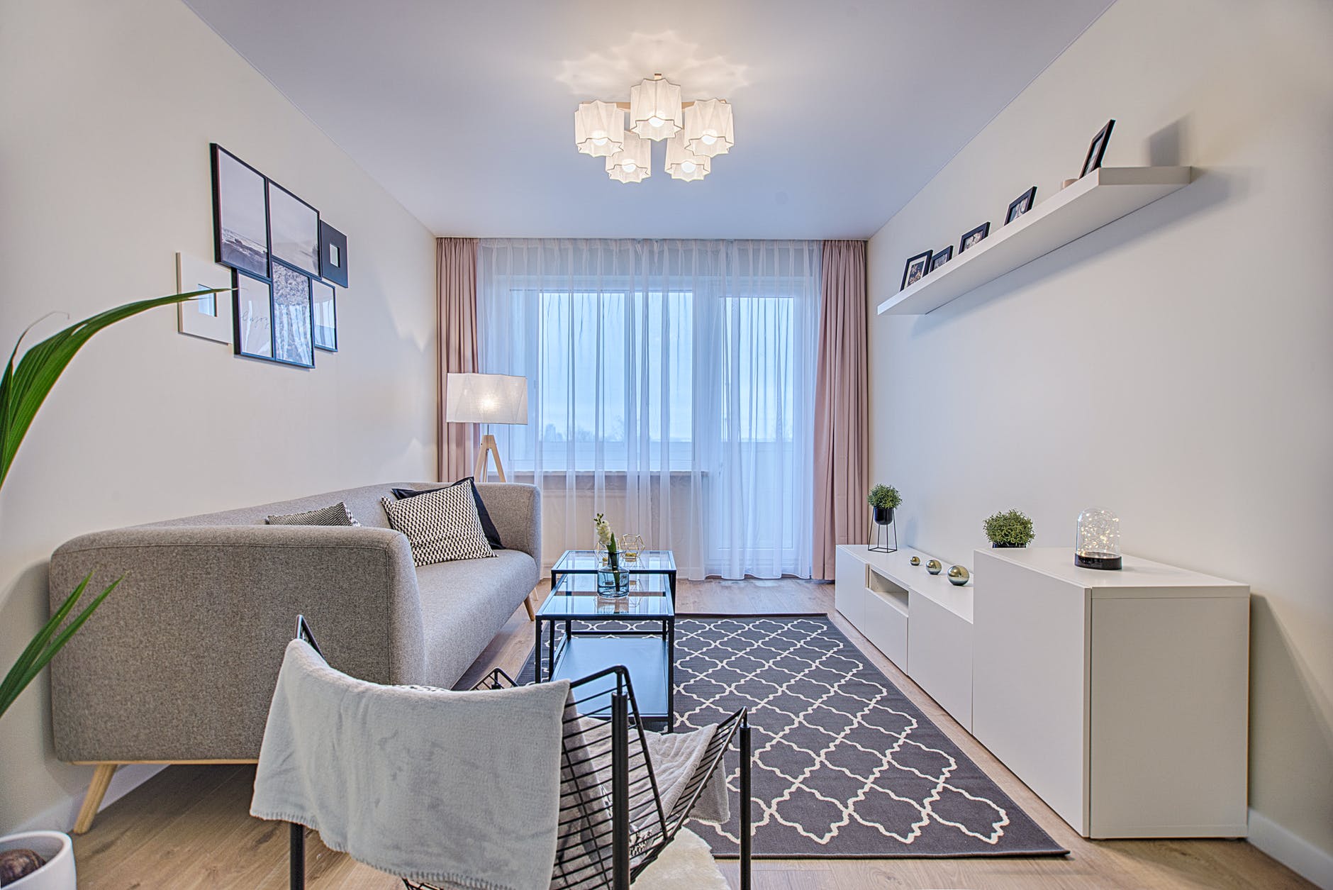 gray fabric padded sofa and glass top coffee table inside living room