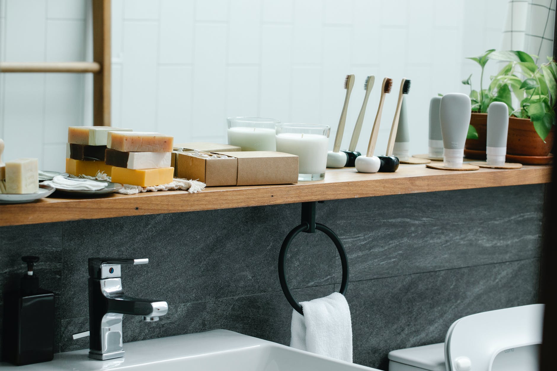 interior of bathroom with brushes and aromatic candles on shelf