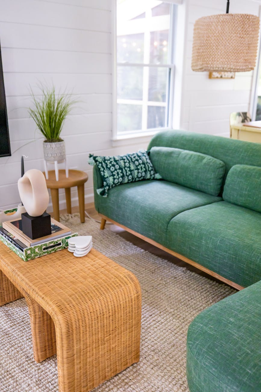 green sofa near brown wooden table