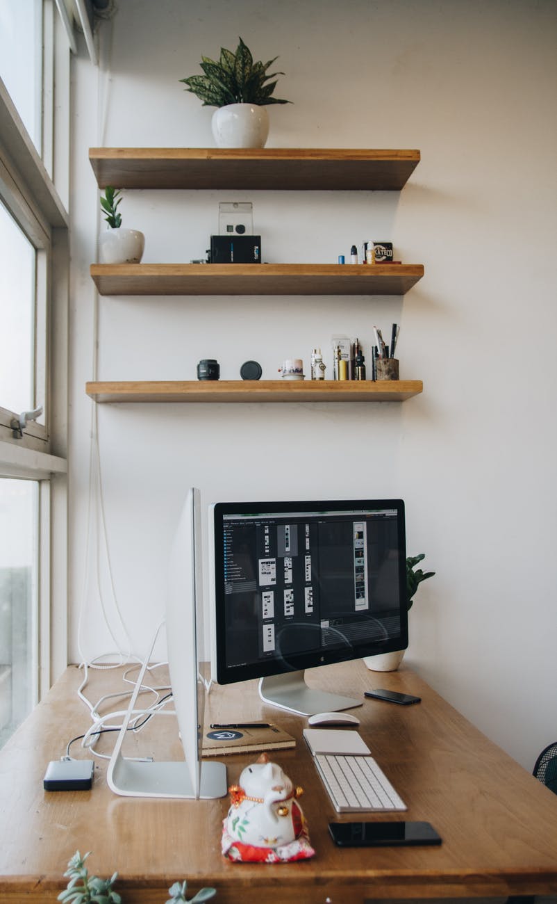 brown wooden floating shelves above small home office