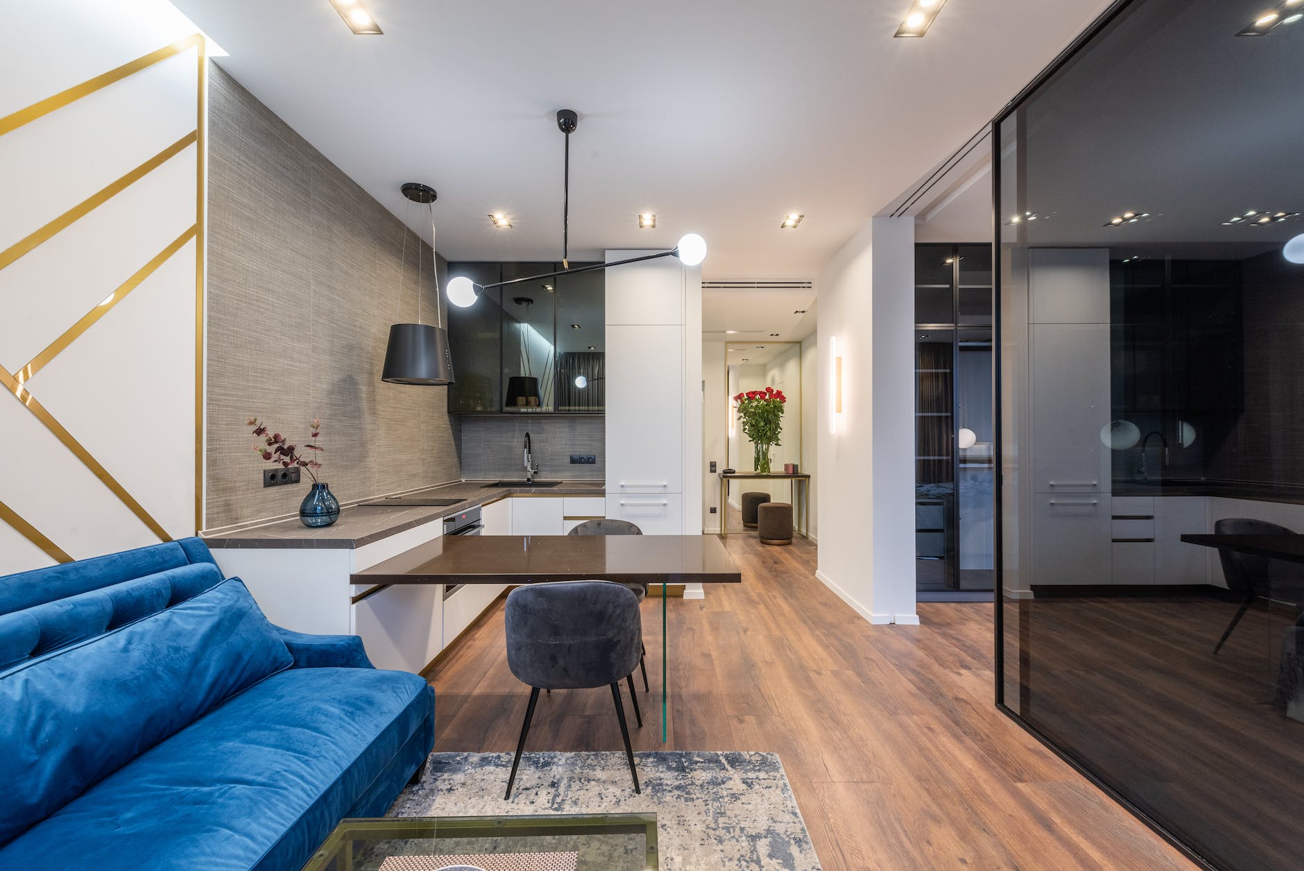 room interior with couch and table with chairs near kitchen